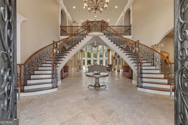 720 Heards Ferry Rd, Atlanta, GA 30328 - entrance foyer with stairway, arched walkways, a towering ceiling, a notable chandelier, and recessed lighting