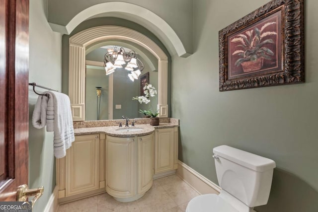 720 Heards Ferry Rd, Atlanta, GA 30328 - half bathroom with toilet, tile patterned floors, vanity, an inviting chandelier, and baseboards