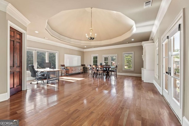 720 Heards Ferry Rd, Atlanta, GA 30328 - dining space with a raised ceiling, wood finished floors, visible vents, a healthy amount of sunlight, and a notable chandelier