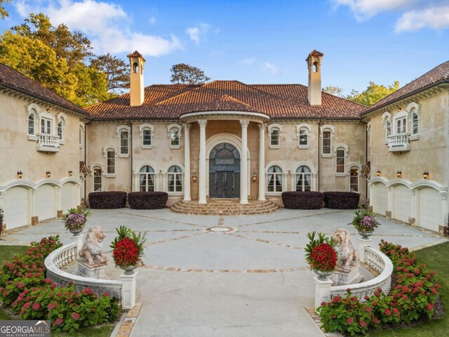 720 Heards Ferry Rd, Atlanta, GA 30328 - mediterranean / spanish home featuring a tile roof, driveway, a chimney, and a garage