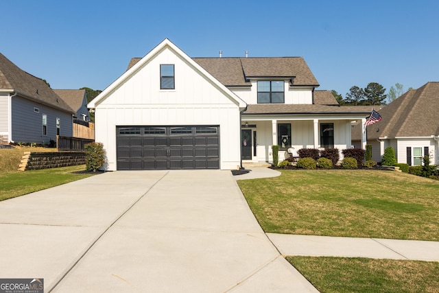 modern farmhouse style home with a front lawn, board and batten siding, an attached garage, and covered porch