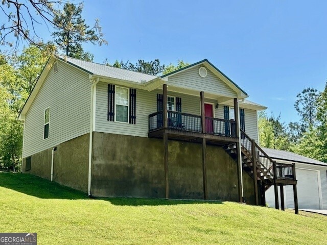 266 W Troutman Rd NE, Rome, GA 30165 - view of front of house with a garage, a porch, a front yard, metal roof, and stairs