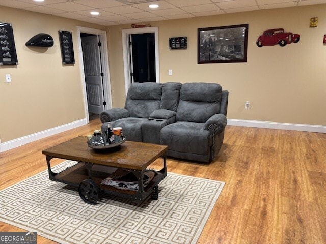 266 W Troutman Rd NE, Rome, GA 30165 - living room with light wood finished floors, a paneled ceiling, and baseboards