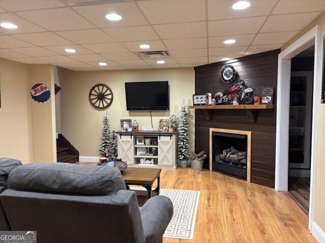 266 W Troutman Rd NE, Rome, GA 30165 - living room featuring visible vents, a paneled ceiling, wood finished floors, and stairs