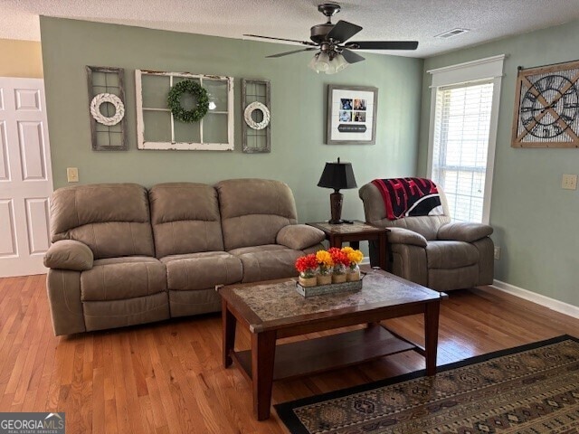 266 W Troutman Rd NE, Rome, GA 30165 - living area with wood finished floors, a textured ceiling, ceiling fan, baseboards, and visible vents
