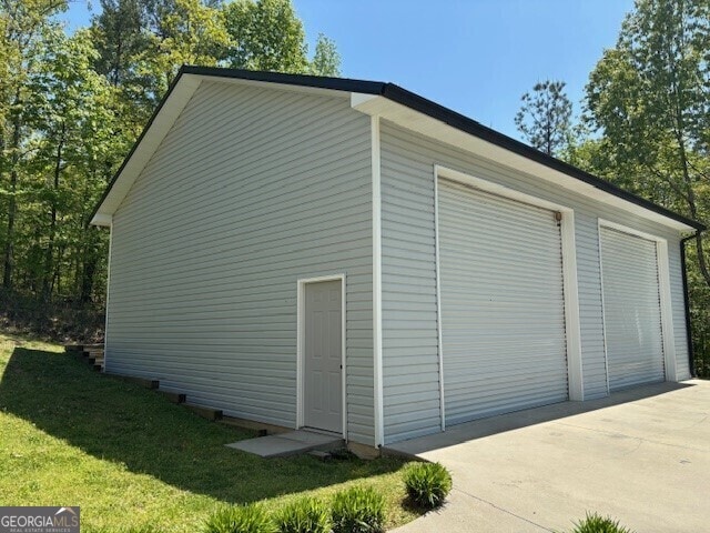 266 W Troutman Rd NE, Rome, GA 30165 - view of property exterior featuring a garage, an outbuilding, and a lawn