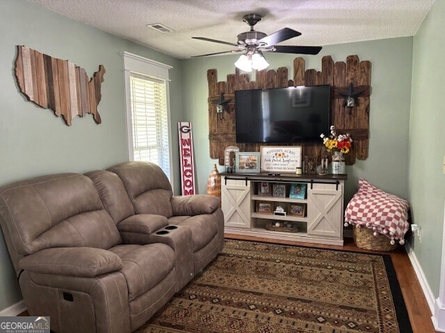 266 W Troutman Rd NE, Rome, GA 30165 - living room featuring wood finished floors, visible vents, baseboards, a textured ceiling, and ceiling fan