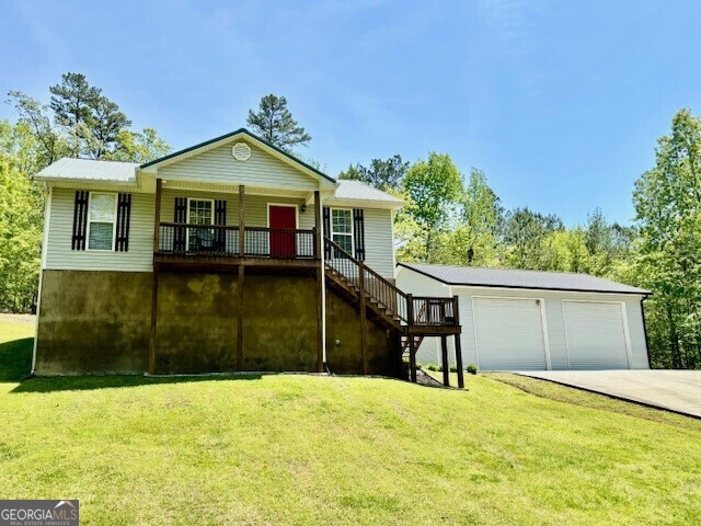 266 W Troutman Rd NE, Rome, GA 30165 - view of front of property featuring a garage, a front lawn, stairway, and a deck