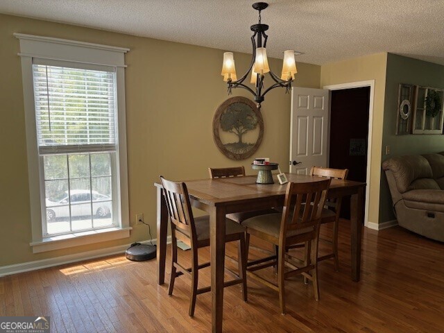 266 W Troutman Rd NE, Rome, GA 30165 - dining area with hardwood / wood-style flooring, an inviting chandelier, a healthy amount of sunlight, and a textured ceiling