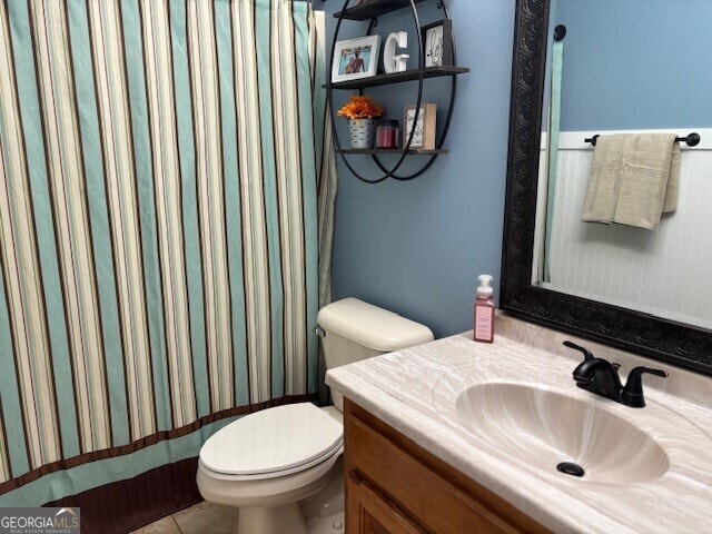 266 W Troutman Rd NE, Rome, GA 30165 - bathroom featuring tile patterned flooring, toilet, vanity, and a shower with shower curtain