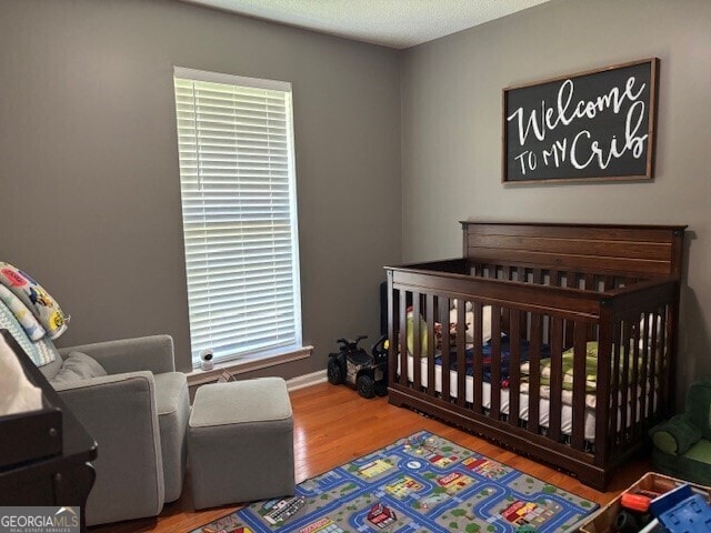 266 W Troutman Rd NE, Rome, GA 30165 - bedroom featuring a nursery area and wood finished floors