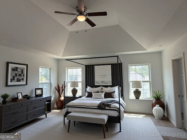 bedroom featuring lofted ceiling, a ceiling fan, and baseboards
