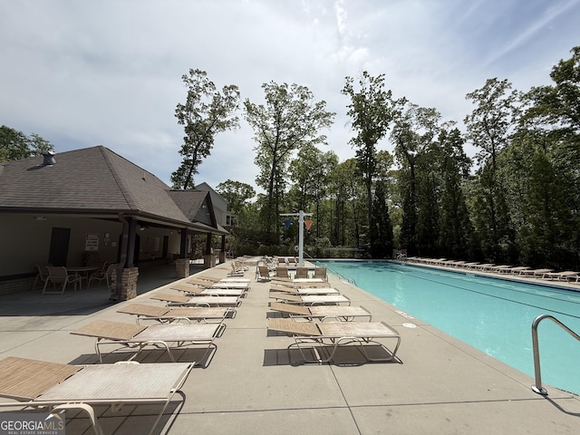 community pool with a patio area