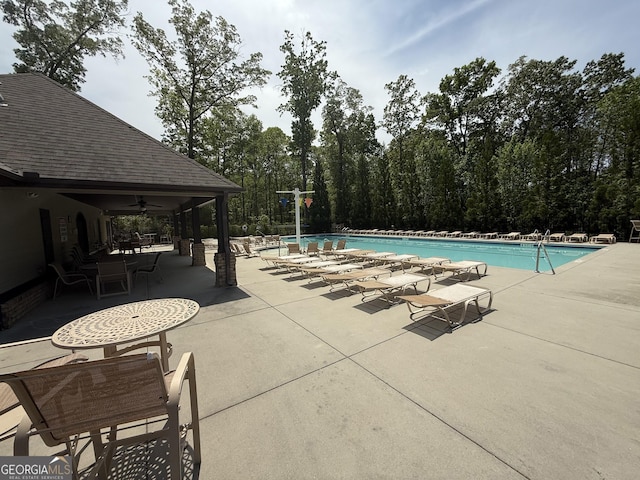 community pool featuring a ceiling fan and a patio