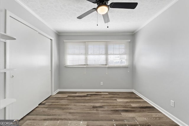 unfurnished bedroom with ceiling fan, a textured ceiling, wood finished floors, a closet, and ornamental molding