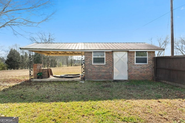 view of outdoor structure featuring fence and an outbuilding