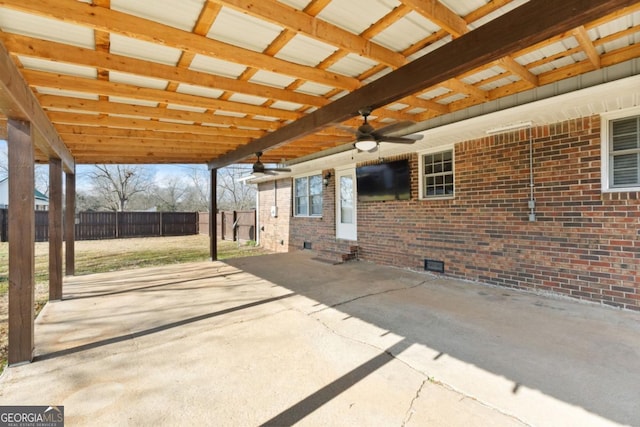 view of patio featuring a ceiling fan and fence