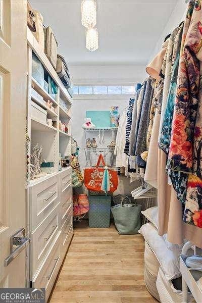 spacious closet with light wood-style flooring