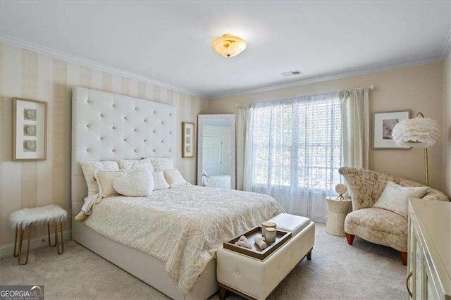 bedroom featuring visible vents, ornamental molding, and carpet floors