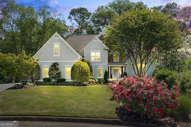 view of front of home featuring a front yard and stucco siding