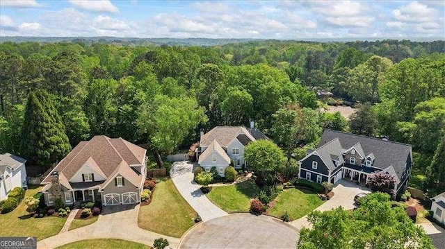 birds eye view of property with a view of trees
