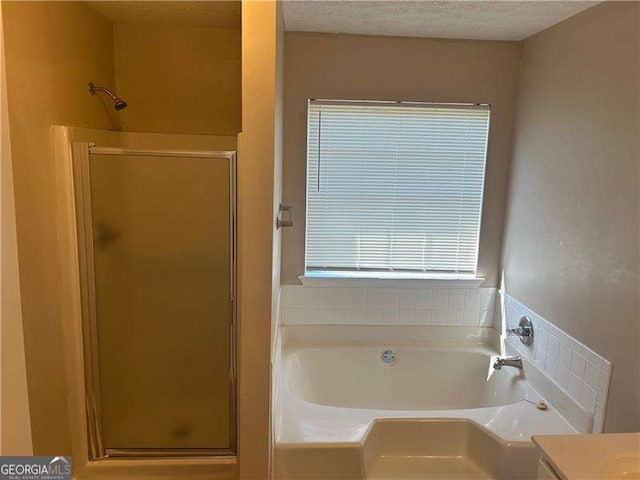 3334 Rockmill Dr, Ellenwood, GA 30294 - bathroom featuring a garden tub, a wealth of natural light, and a stall shower