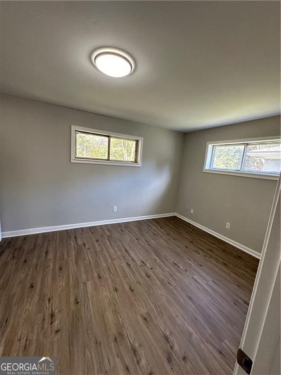1401 Vesta Ave, East Point, GA 30344 - spare room featuring baseboards and dark wood finished floors