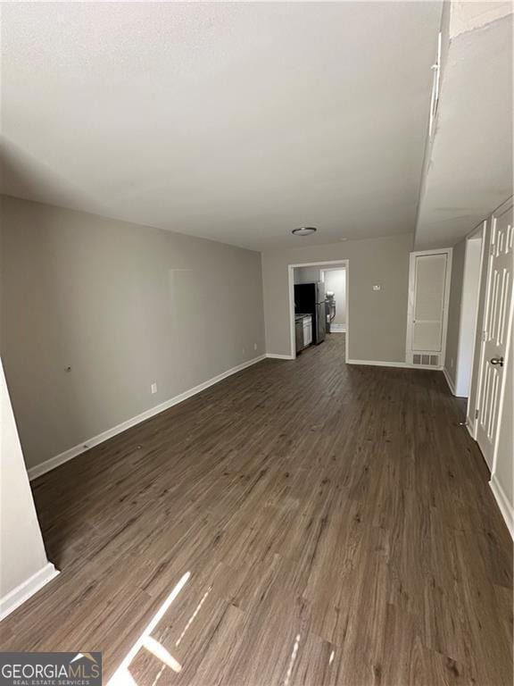 1401 Vesta Ave, East Point, GA 30344 - unfurnished living room featuring baseboards, visible vents, and dark wood-style floors