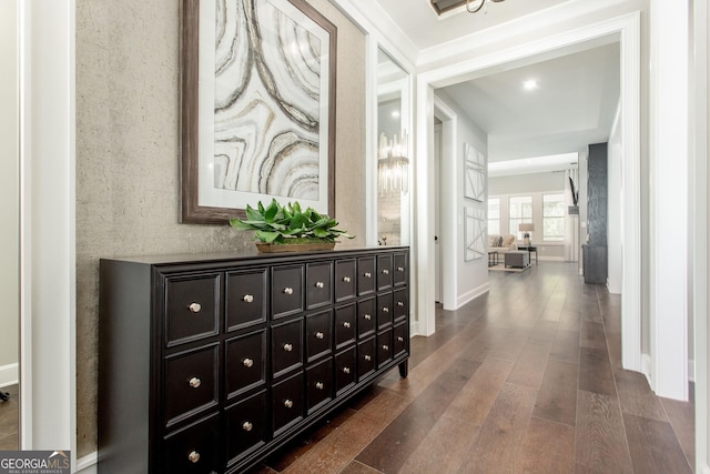 corridor with dark wood finished floors and baseboards