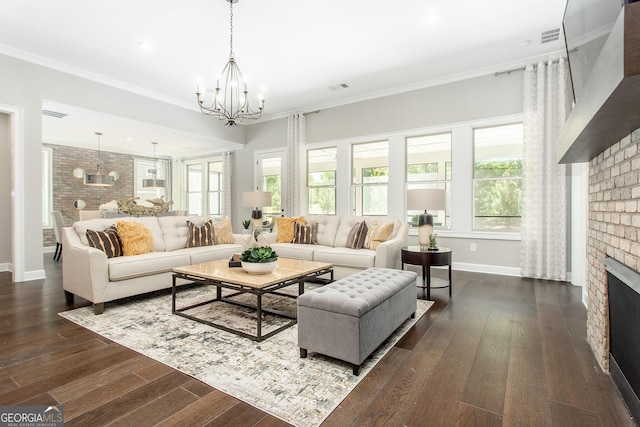 living area with baseboards, a fireplace, a notable chandelier, and dark wood finished floors