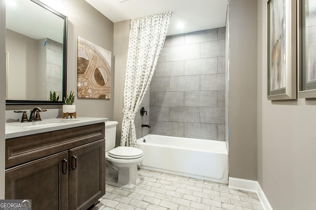 bathroom with bathtub / shower combination, baseboards, vanity, and toilet