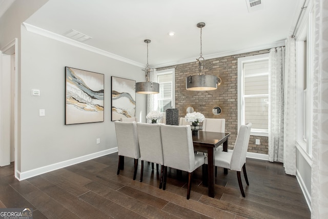 dining space featuring baseboards, visible vents, dark wood-style floors, and crown molding