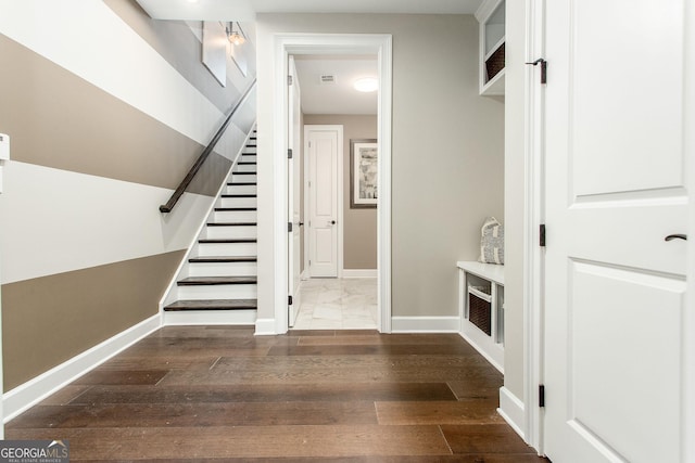 interior space with wood finished floors and baseboards