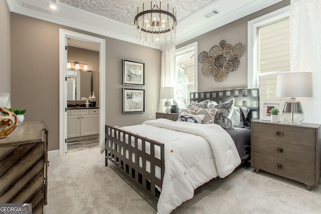 bedroom with ensuite bath, visible vents, light colored carpet, and an inviting chandelier