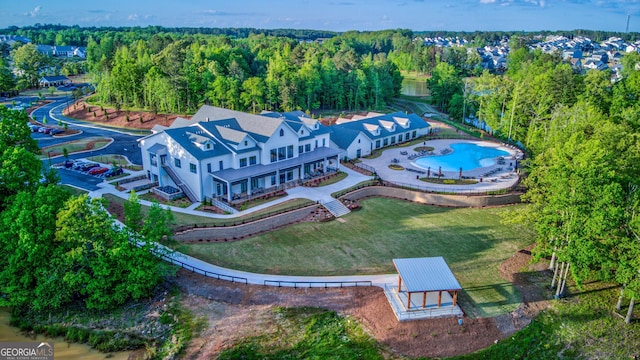 birds eye view of property featuring a wooded view