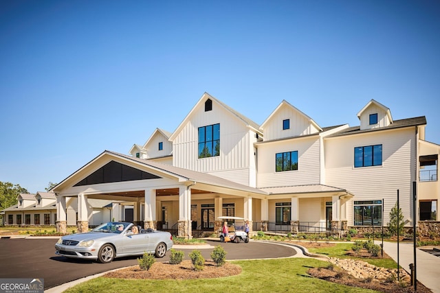 view of front facade featuring board and batten siding and a front lawn