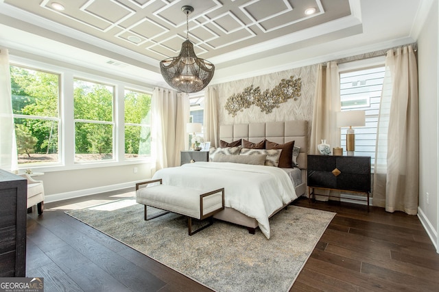 bedroom with a chandelier, a raised ceiling, and baseboards