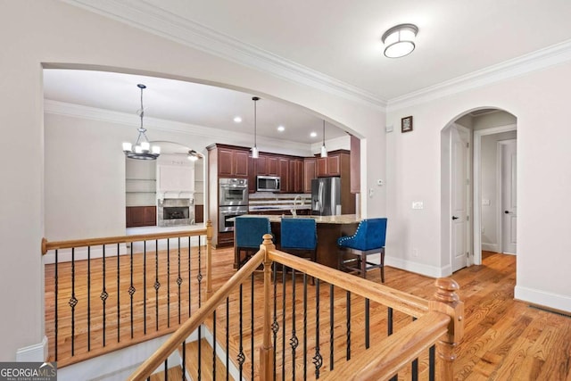 930 Riverside Rd, Roswell, GA 30075 - interior space with arched walkways, crown molding, light wood-type flooring, a chandelier, and recessed lighting