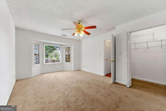 1170 Moseley Rd, Stockbridge, GA 30281 - unfurnished bedroom featuring baseboards, carpet flooring, a textured ceiling, and a closet