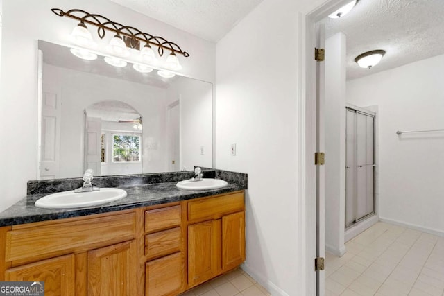 1170 Moseley Rd, Stockbridge, GA 30281 - bathroom with a shower stall, a textured ceiling, and a sink