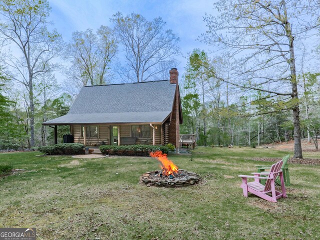 410 Whiskey Still Dr, Cleveland, GA 30528 - view of property exterior featuring a lawn, a fire pit, roof with shingles, and log exterior