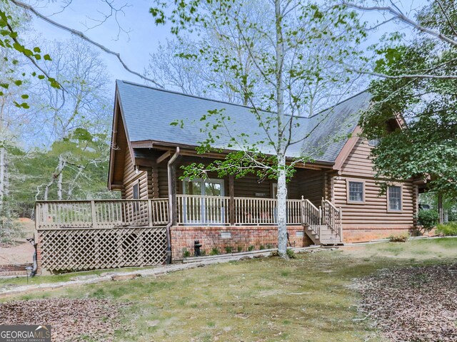 410 Whiskey Still Dr, Cleveland, GA 30528 - log home featuring a shingled roof, log siding, and covered porch