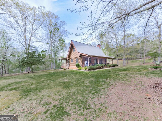 410 Whiskey Still Dr, Cleveland, GA 30528 - view of side of home featuring a yard, a chimney, and log siding