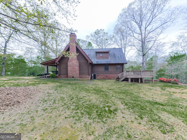 410 Whiskey Still Dr, Cleveland, GA 30528 - view of side of property featuring a lawn, a chimney, log siding, and a deck