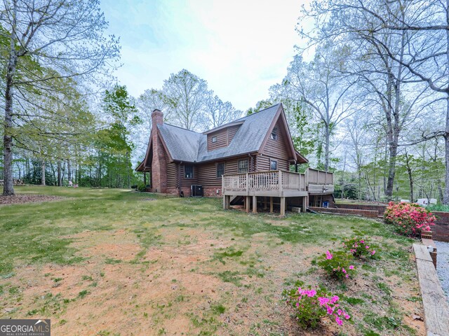 410 Whiskey Still Dr, Cleveland, GA 30528 - rear view of house featuring a chimney, central air condition unit, a yard, a wooden deck, and log exterior