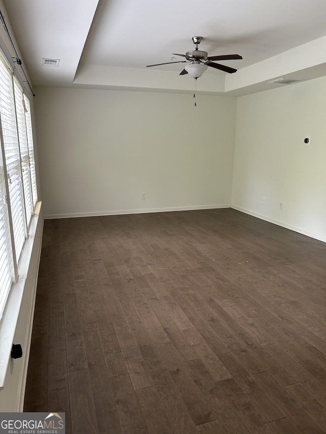 3908 Augustine Pl, Rex, GA 30273 - spare room featuring dark wood-style flooring, a ceiling fan, visible vents, and baseboards