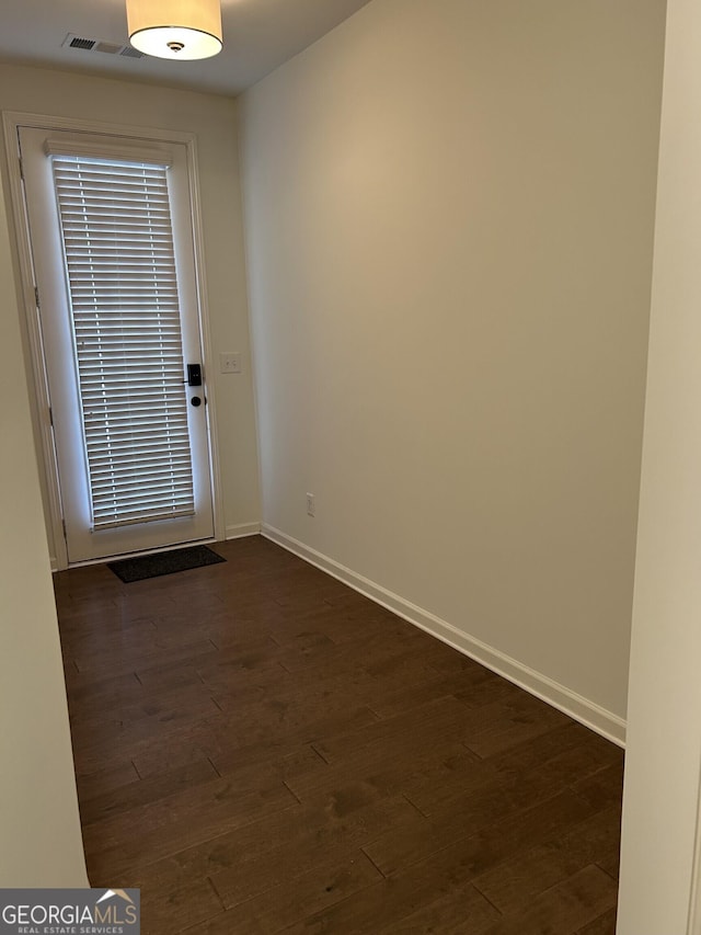 3908 Augustine Pl, Rex, GA 30273 - doorway featuring visible vents, baseboards, and dark wood-type flooring