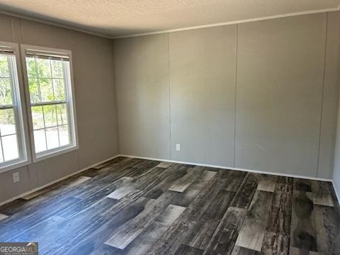 908 Bethel Freewill Rd, Baxley, GA 31513 - spare room with wood finished floors and a textured ceiling
