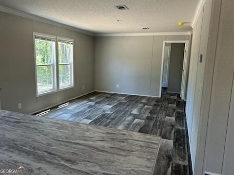 908 Bethel Freewill Rd, Baxley, GA 31513 - empty room featuring crown molding, dark wood-type flooring, and a textured ceiling