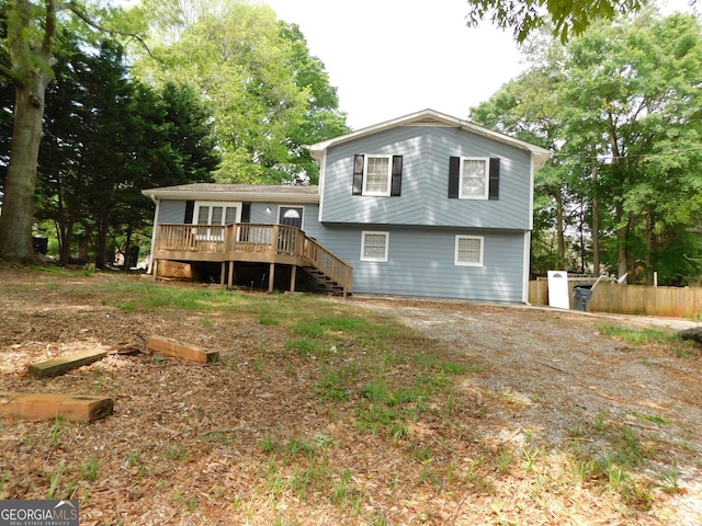 back of house featuring a deck, stairway, and fence